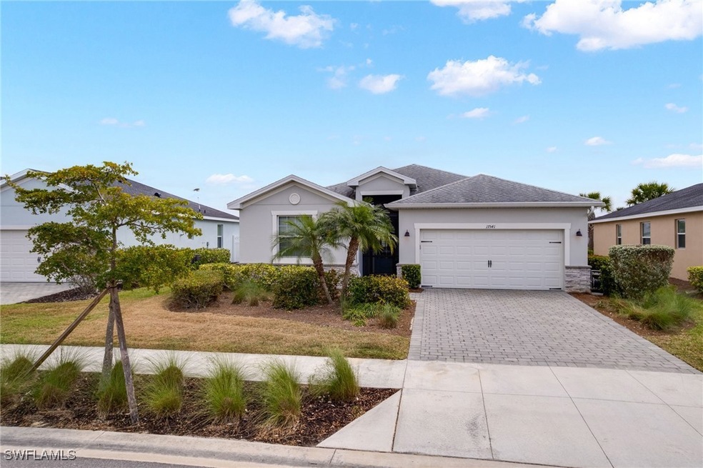 Single story home featuring decorative driveway, s