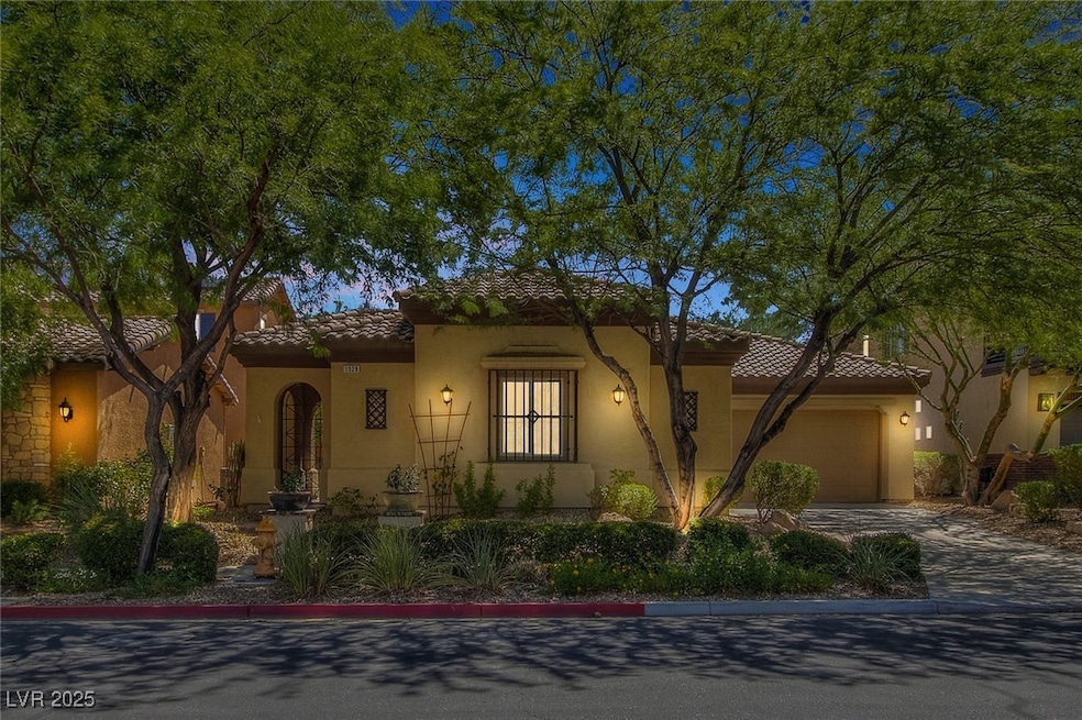 Mediterranean / spanish-style house featuring a tiled roof, driveway, an attached garage, and stucco siding