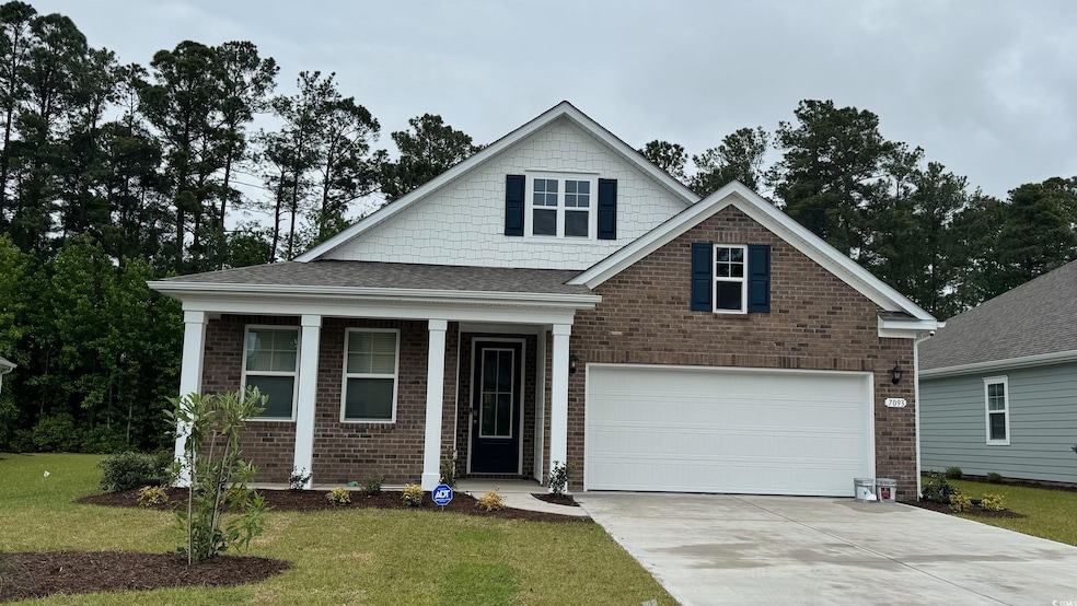 Craftsman-style house with concrete driveway, a fr