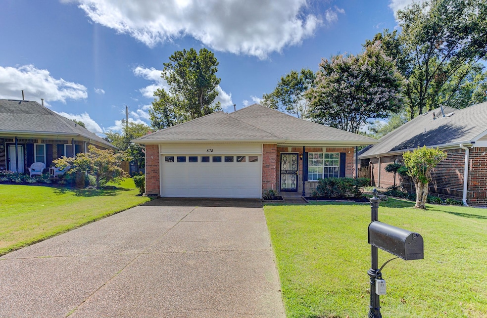 Single story home featuring brick siding, driveway, a garage, and a front lawn