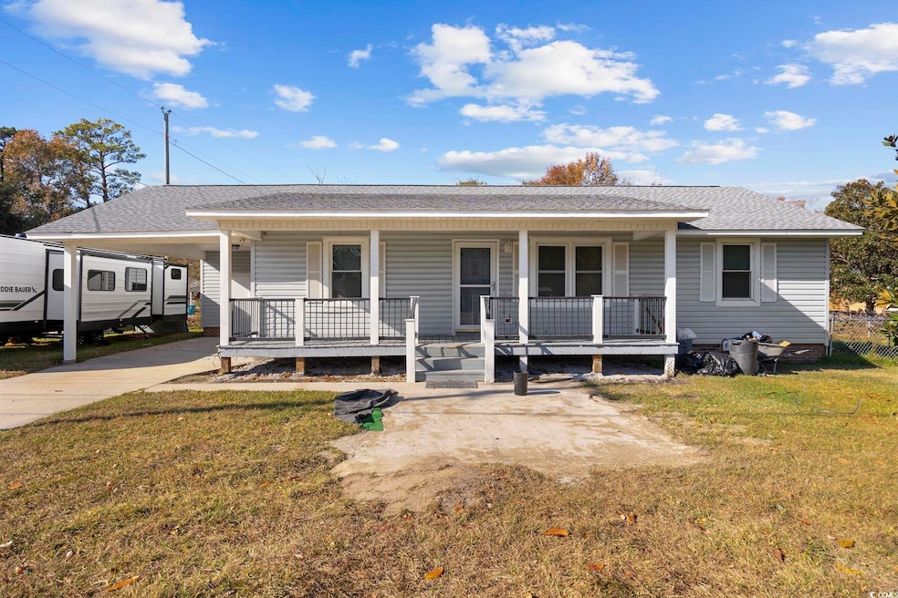 View of front of home featuring a porch, roof with shingles, and a front lawn