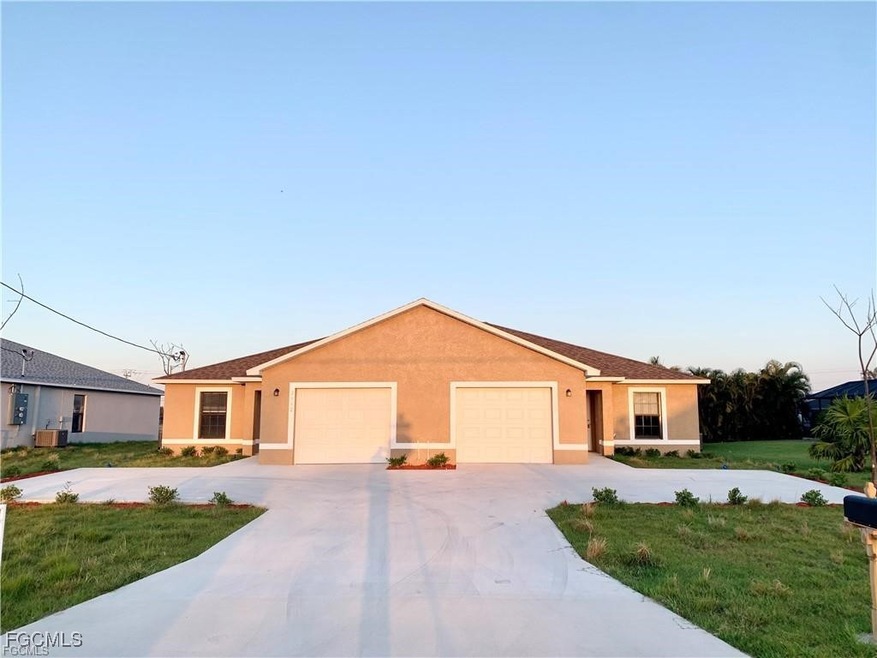 Ranch-style house featuring stucco siding, a front yard, and driveway