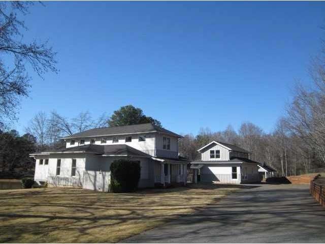 Exterior Front. View of main house and larger gara