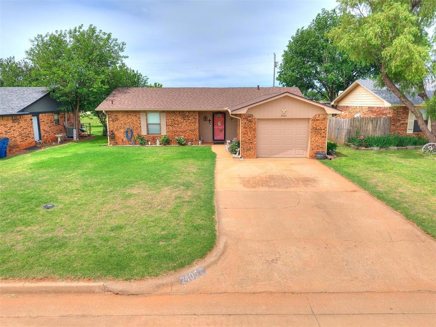 Ranch-style house with a garage, driveway, brick s