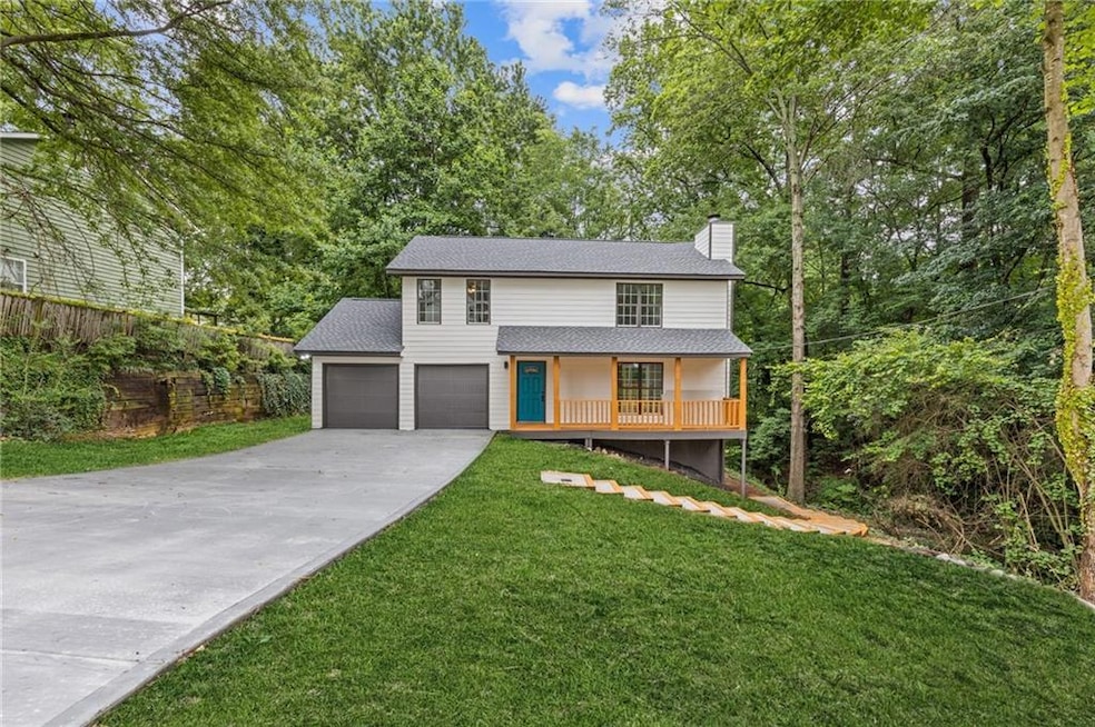 View of front of property featuring a chimney, concrete driveway, a front yard, a porch, and a shingled roof
