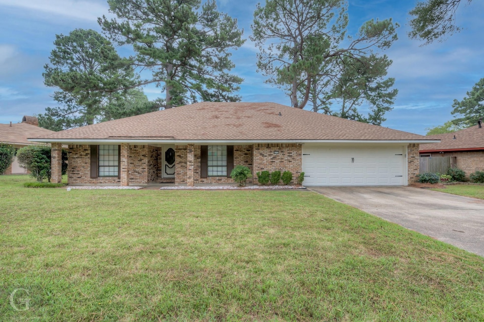 Single story home featuring a garage and a front l
