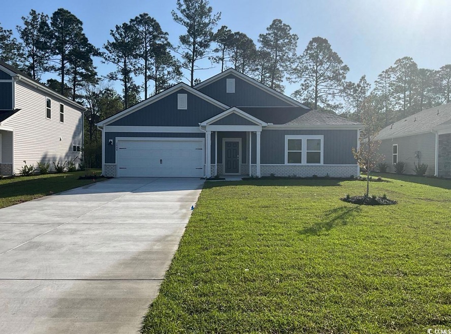 Craftsman-style home with an attached garage, driv