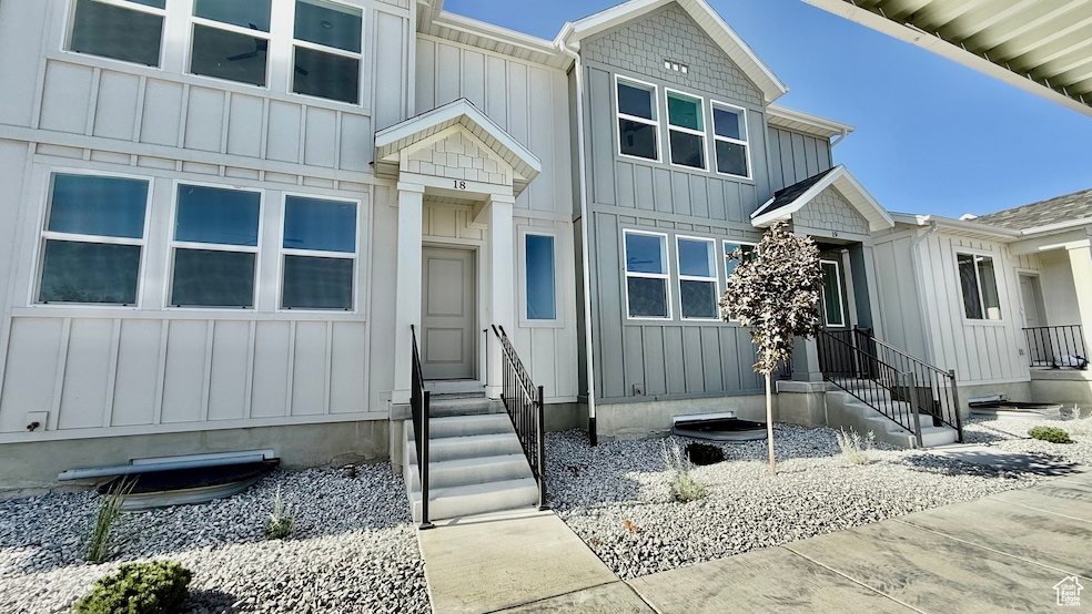 View of front of home featuring board and batten siding and entry steps