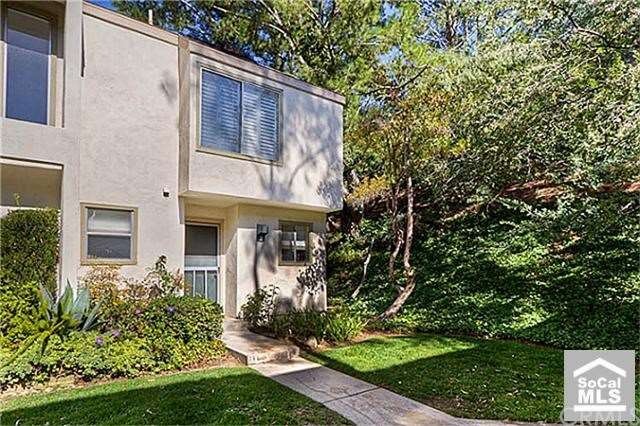 Charming end unit tucked into wooded area