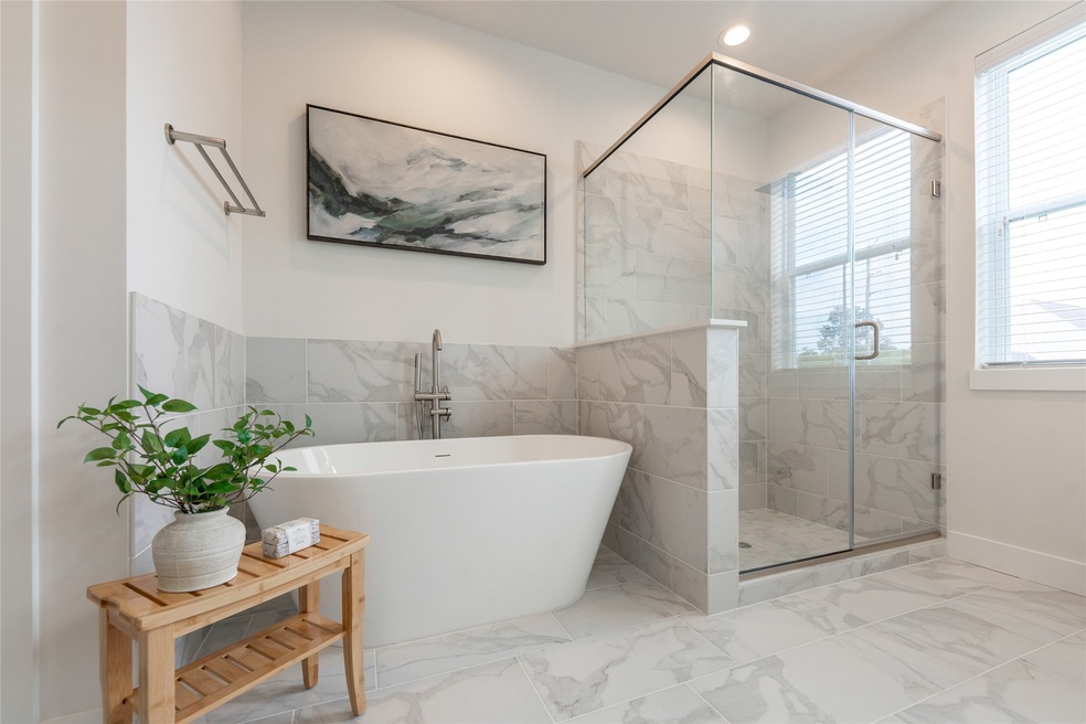 Elegant primary bath featuring a luxurious soaking