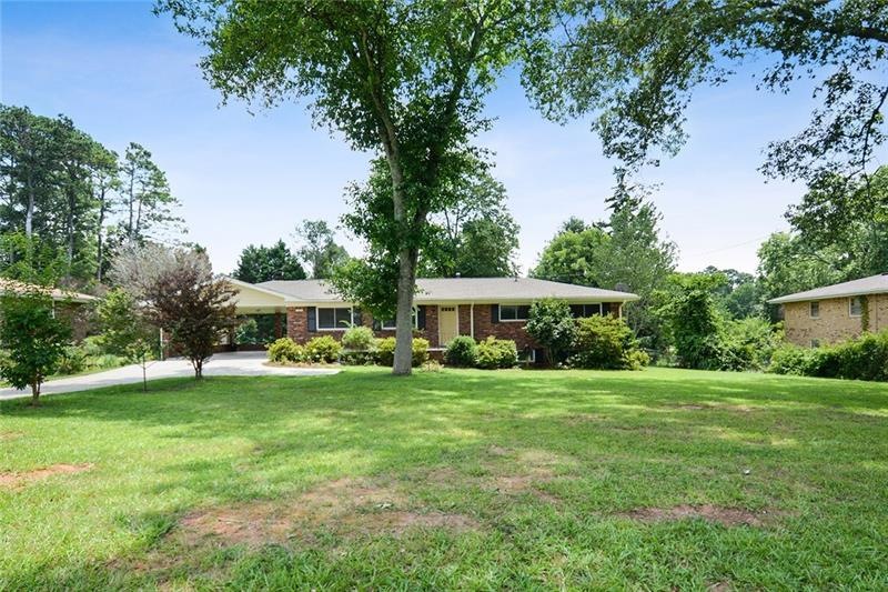 Sitting beautifully on this oversized lot, this br