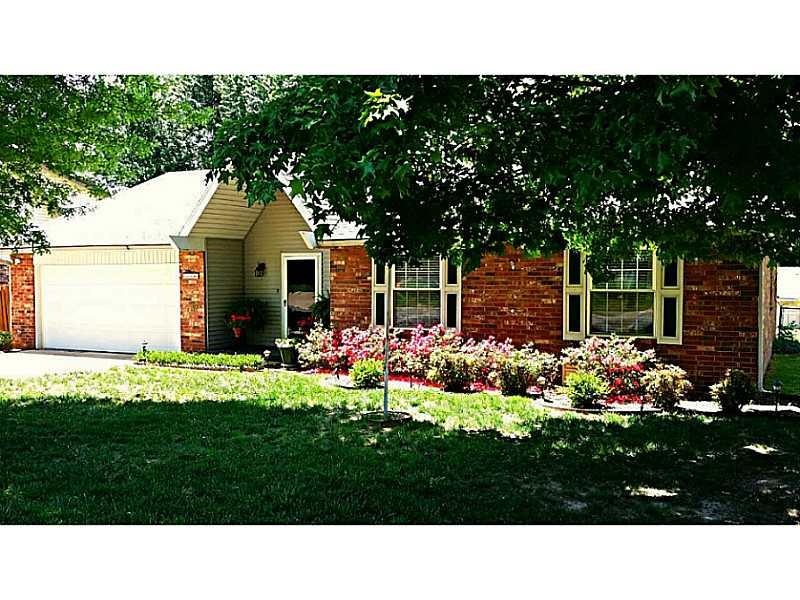 Exterior Front. Beautiful landscaping with sprinkl