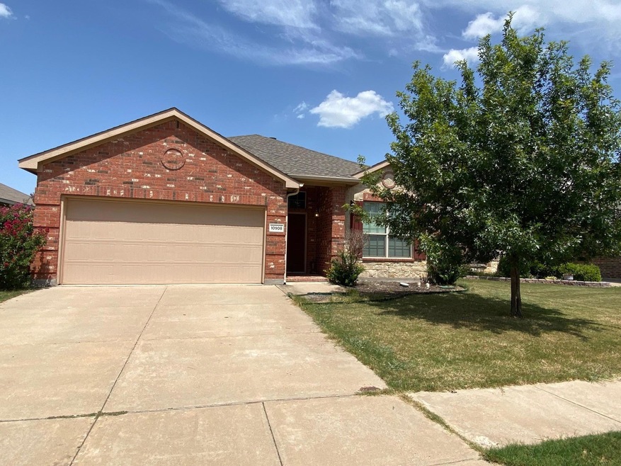 View of front of home with a garage and a front lawn