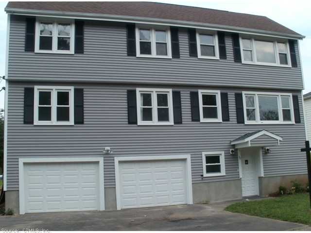 Exterior Front. Front view with 2 car garage and d