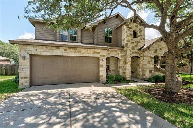 Beautiful stone two story home with huge shade tree in front!