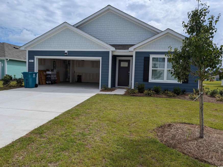 View of front facade with a garage and a front law