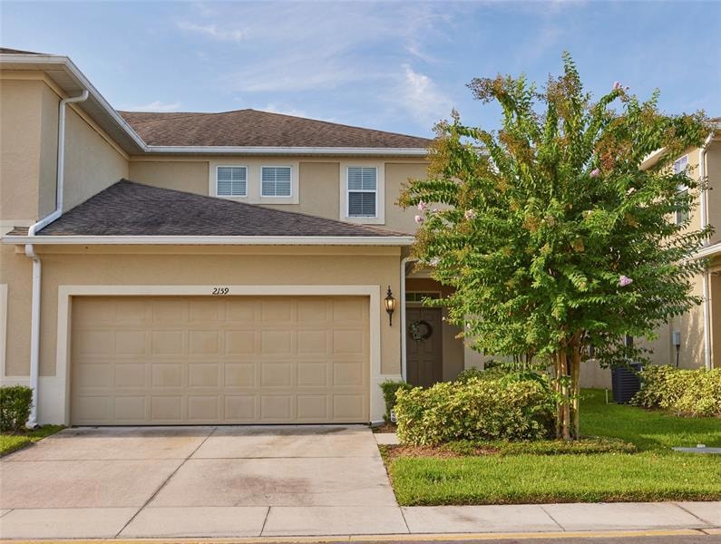 Exterior front. This home includes a 2-car garage that allows room for 4 parking spaces and opens to the kitchen and laundry. This landscape includes a beautiful Crape Myrtle tree. Maintenance of the grounds is included in the HOA.