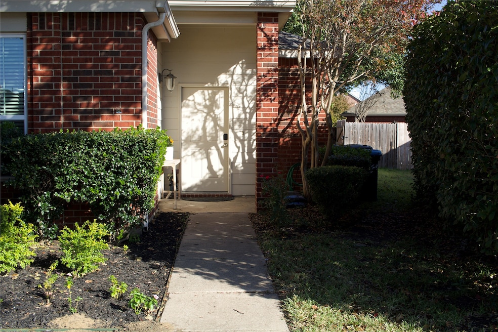 View of exterior entry featuring brick siding