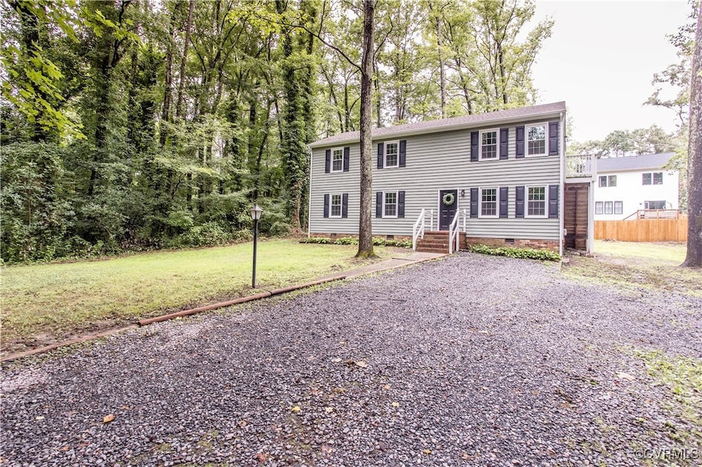Colonial home featuring crawl space and a front la