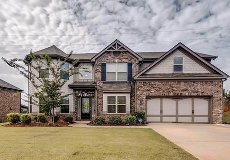 Craftsman inspired home with brick siding, an atta