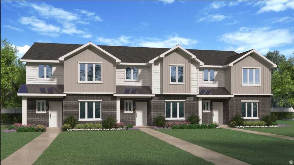 View of front of home featuring a front yard, brick siding, a residential view, a metal roof, and a standing seam roof