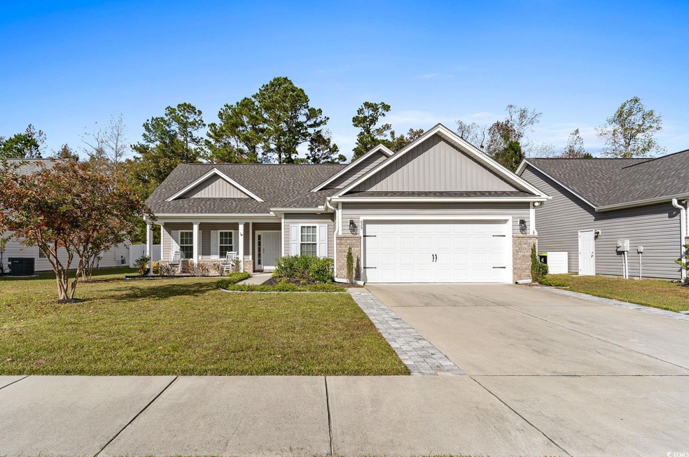 Craftsman-style house featuring a garage, covered 