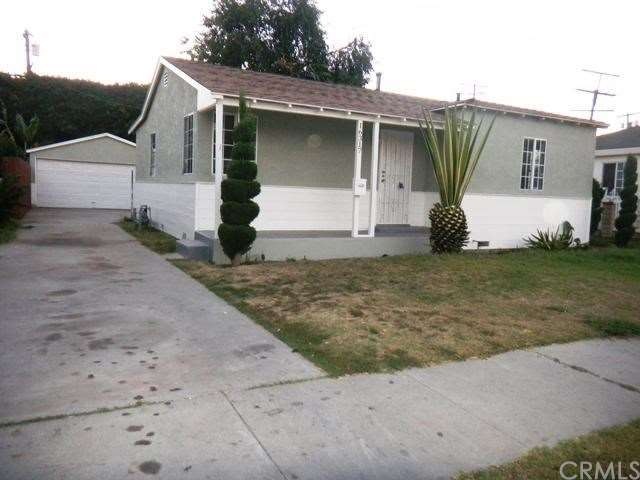 Front view of home and long driveway leading to ga