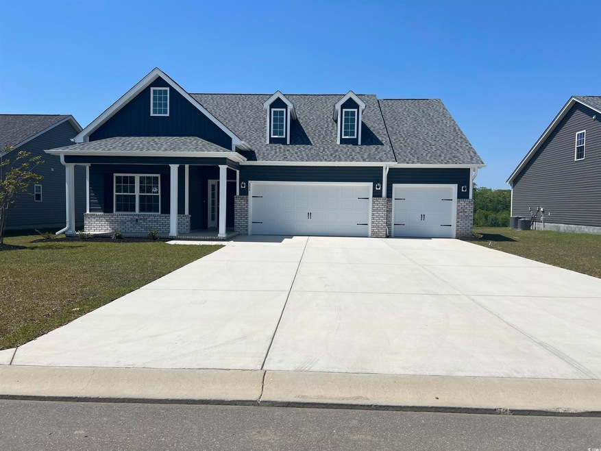 Craftsman house with an attached garage, covered p