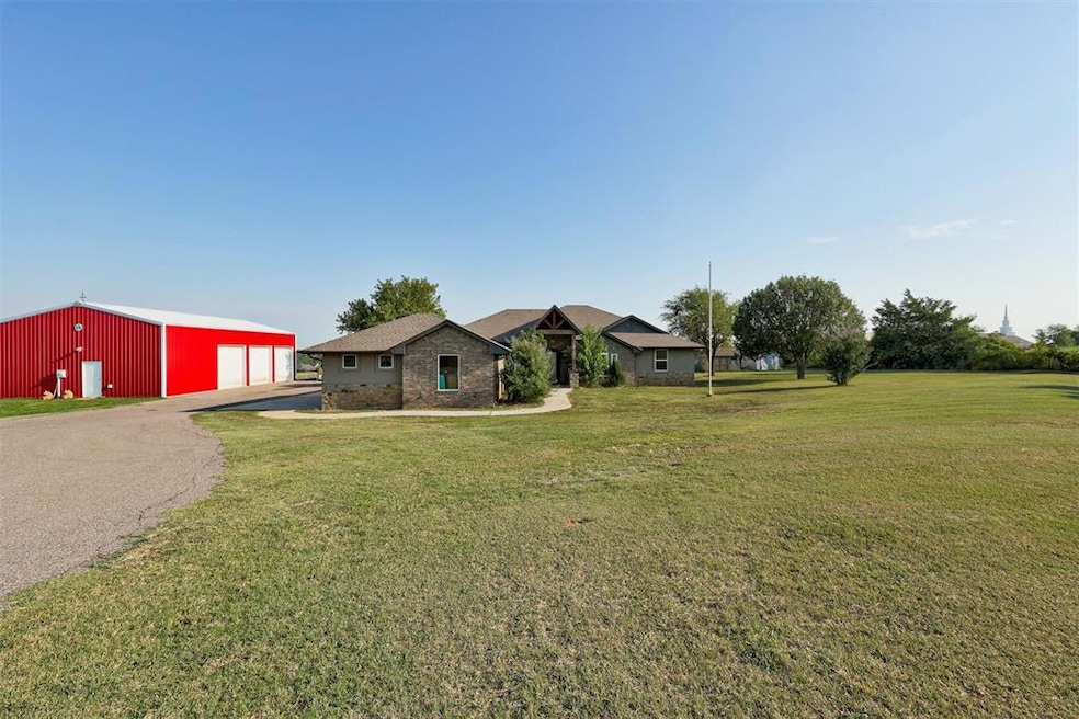 Single story home with an outbuilding and a front 
