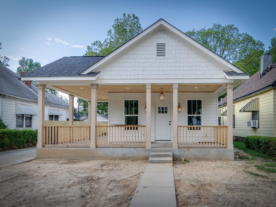 View of front facade with covered porch, cooling unit, and roof with shingles