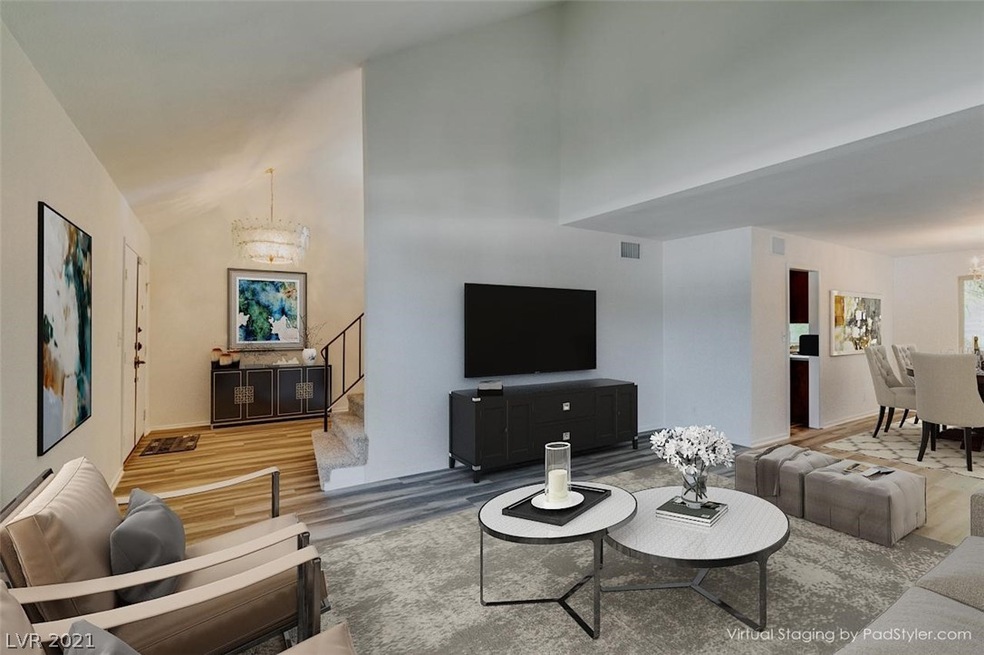 The living room has vaulted ceilings and connects