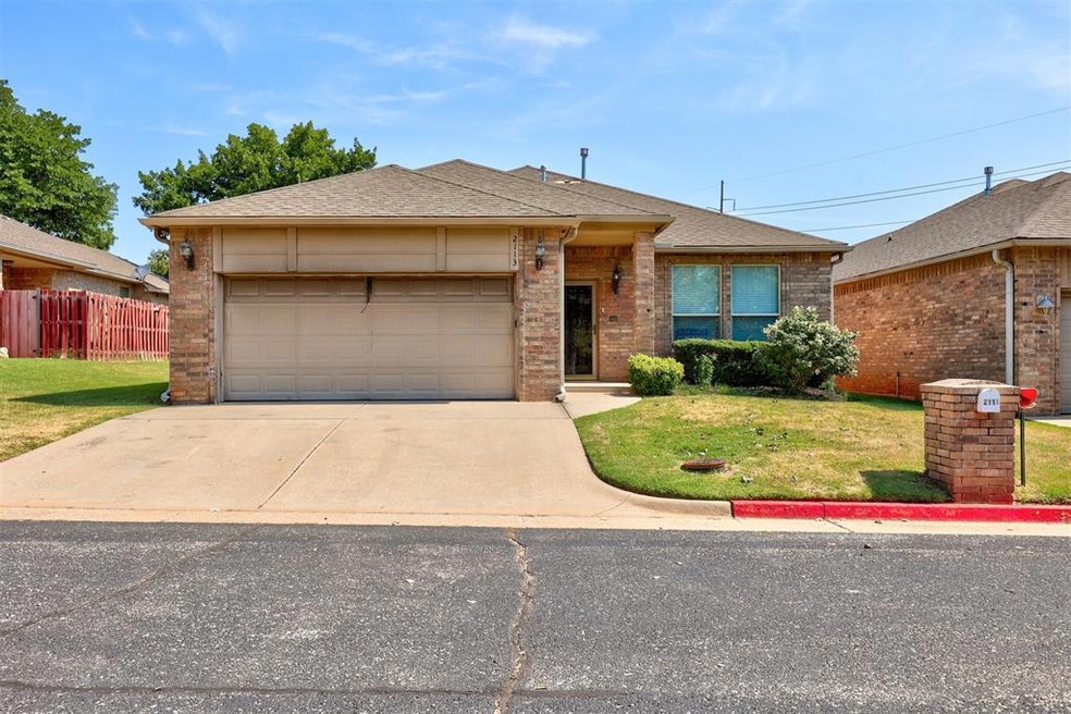 Ranch-style house with a front lawn and a garage