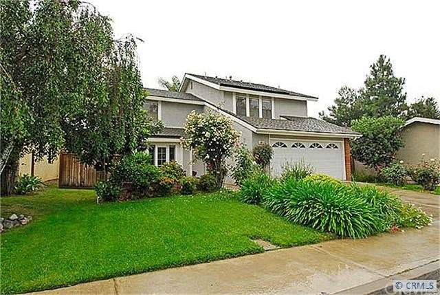 Home at a distance showing front yard.