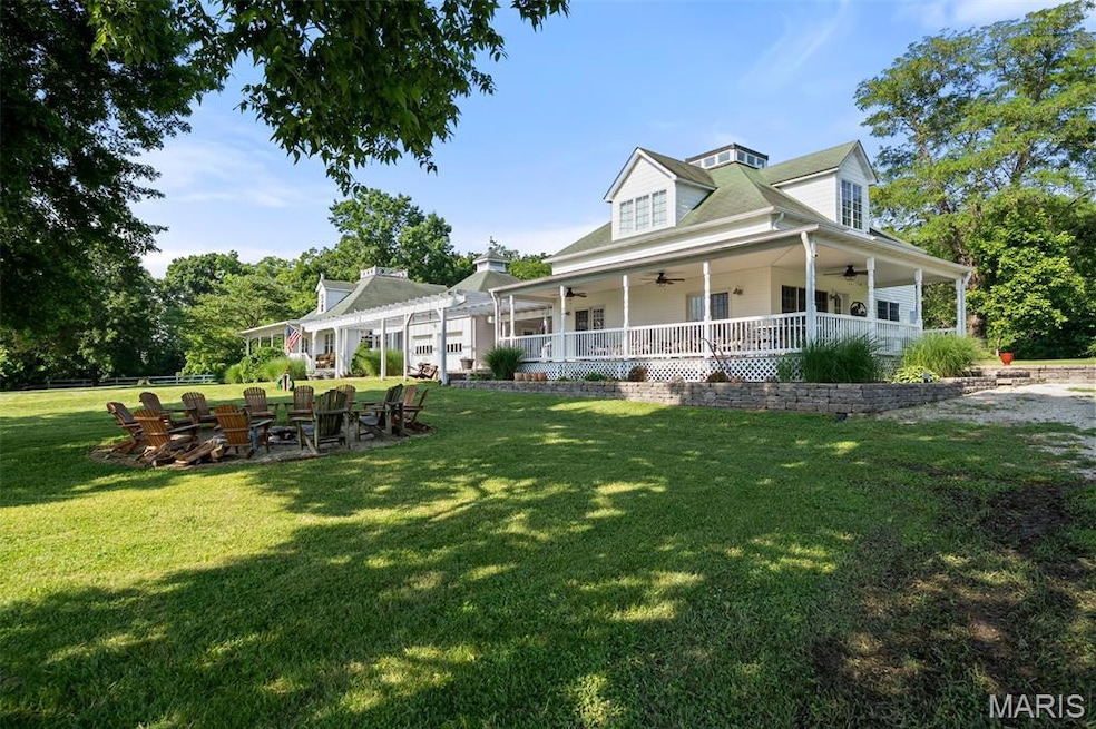 View of front of house featuring a ceiling fan and a patio area