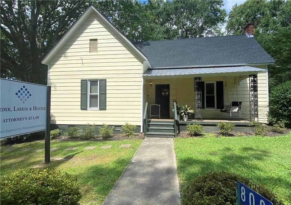 Bungalow-style home with crawl space, a front lawn, covered porch, and a chimney