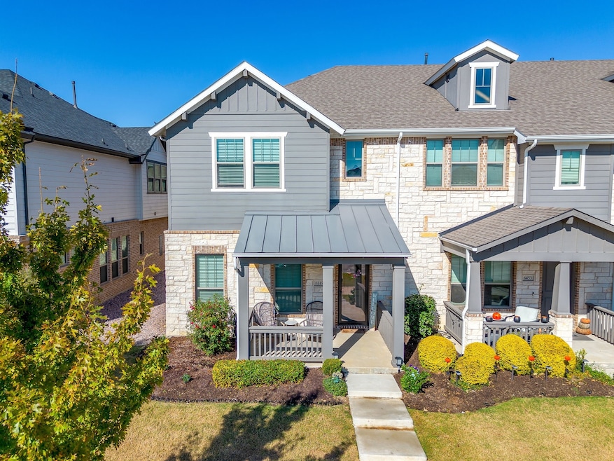 Craftsman-style house featuring stone siding, a porch and a front yard