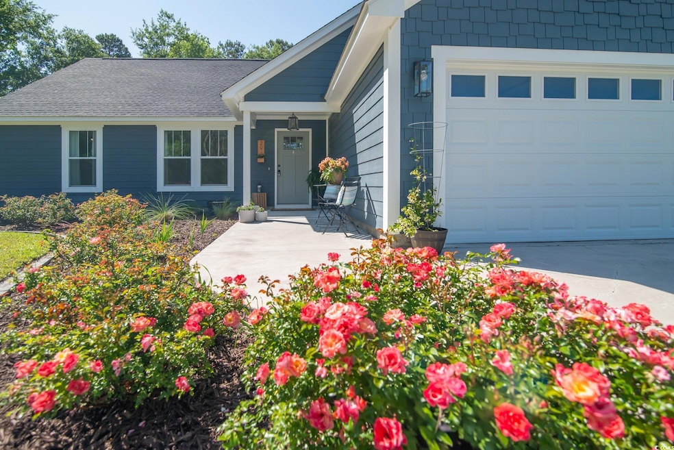 Single story home featuring concrete driveway and a garage
