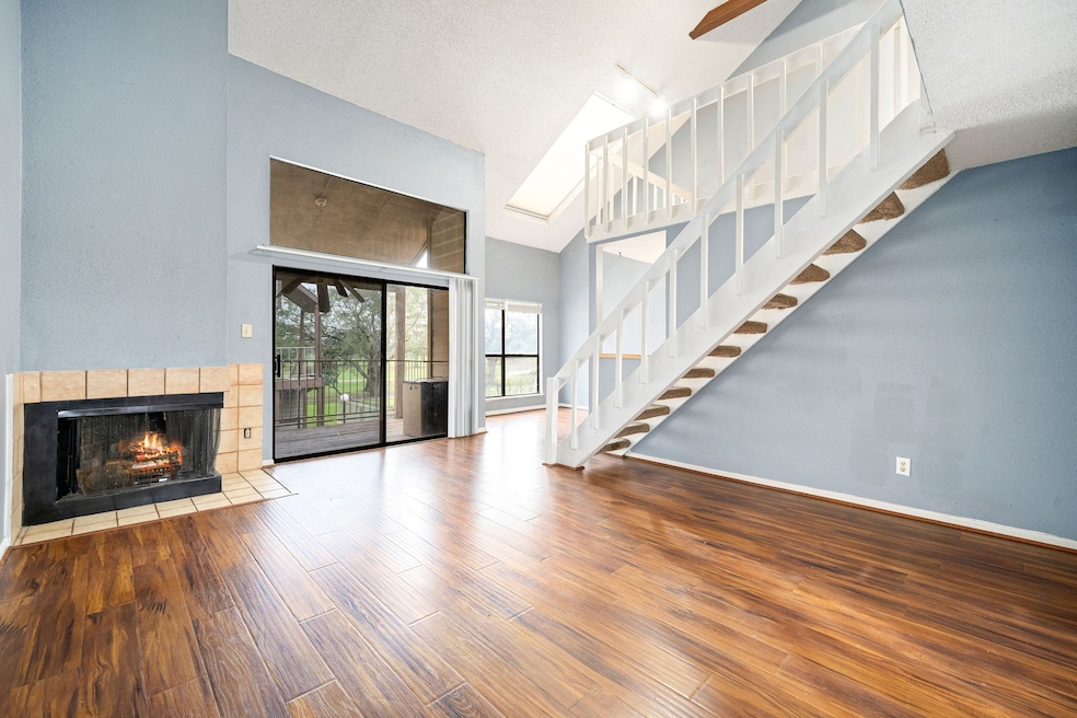This bright living room features a cozy fireplace
