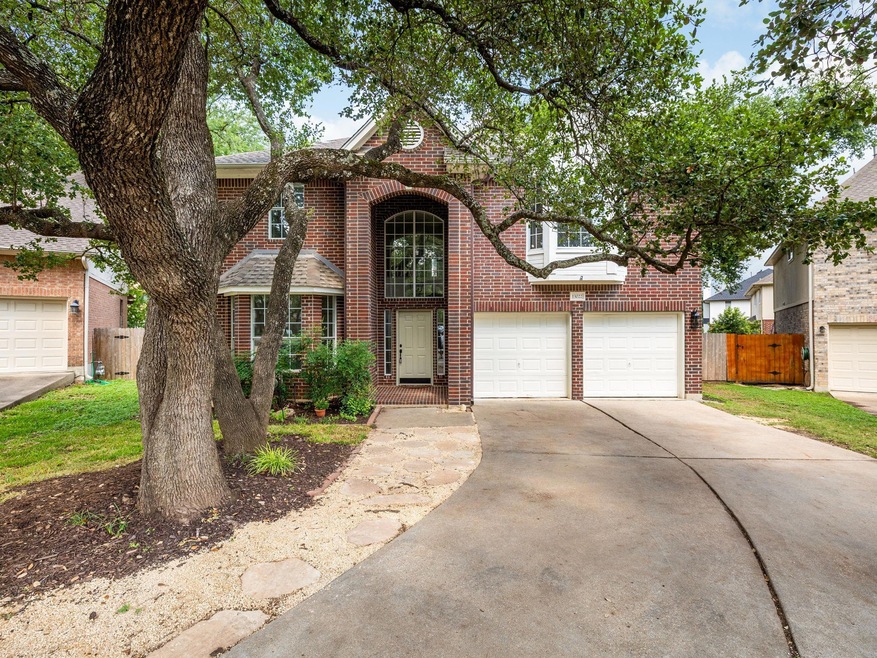 Traditional home featuring brick siding, driveway