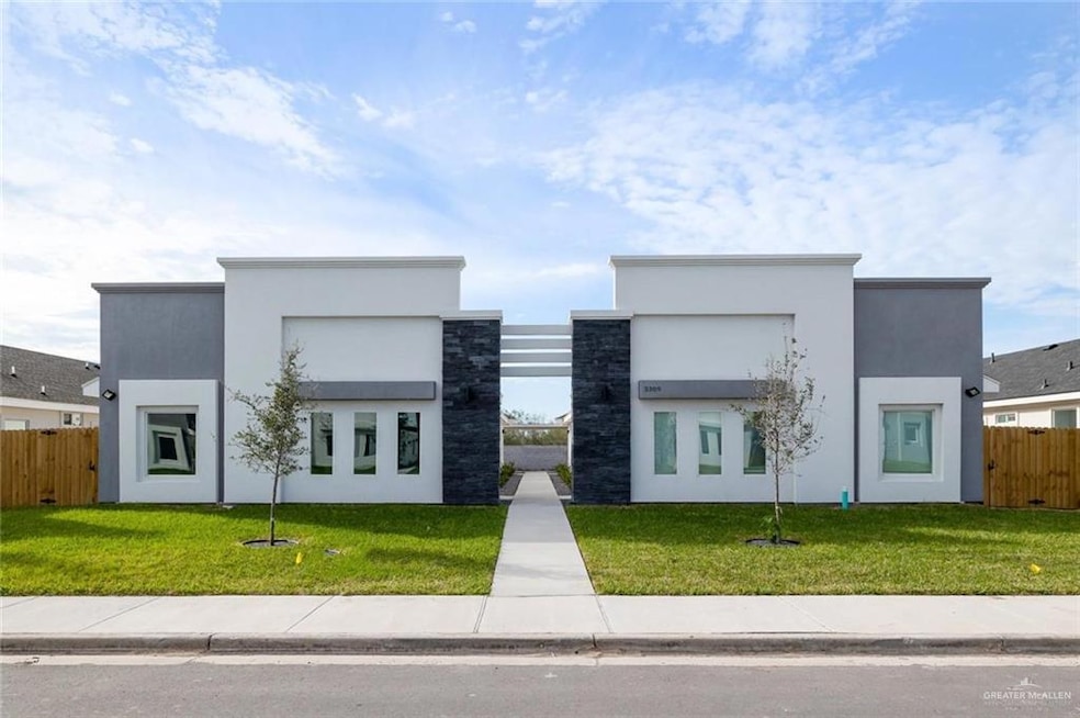 Contemporary home featuring stucco siding, fence, and a front lawn