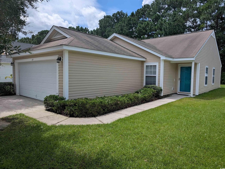 Single story home featuring a front yard, a shingled roof, concrete driveway, and an attached garage