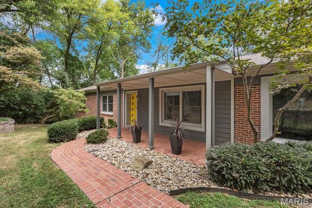 Front of home. Bricked walkway and inviting front porch
