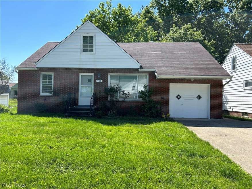 View of front facade featuring a garage and a front yard