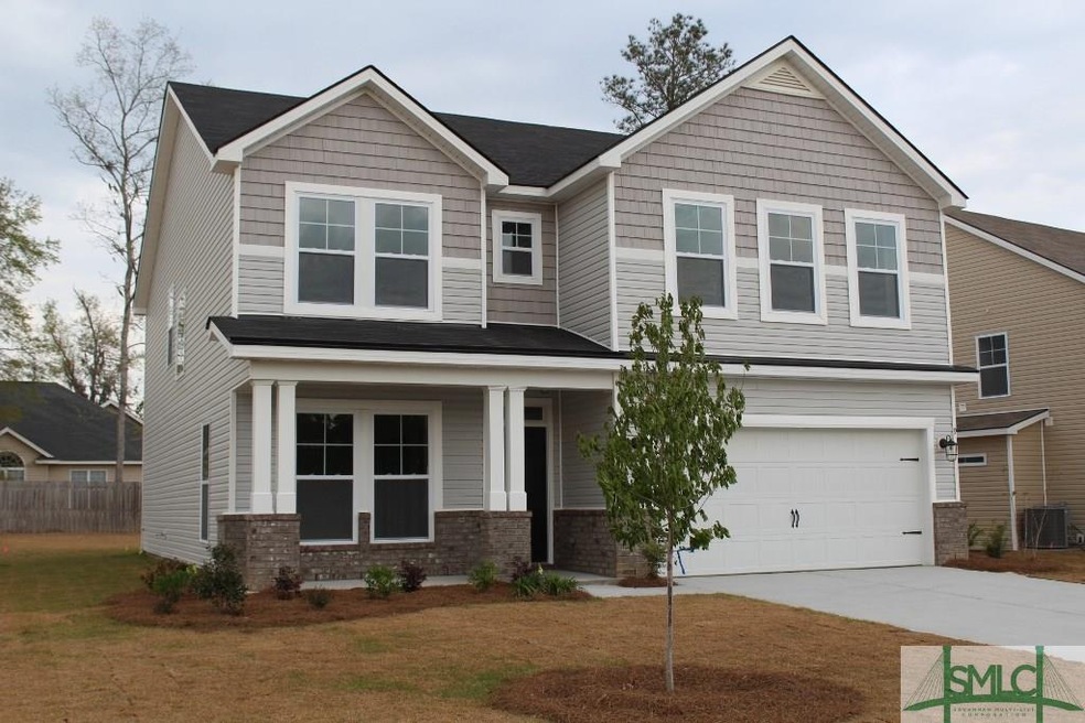 front of home with full landscaping and sprinkler 