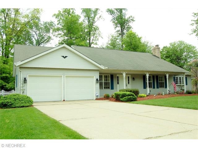 Lovely Cape Cod with dual garage door access controlled by two openers.  Note attractive light fixtures either side of garage doors and at front entrance to home.
