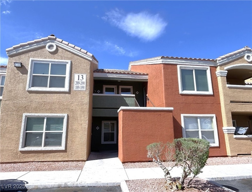 Multi unit property featuring a tile roof and stuc