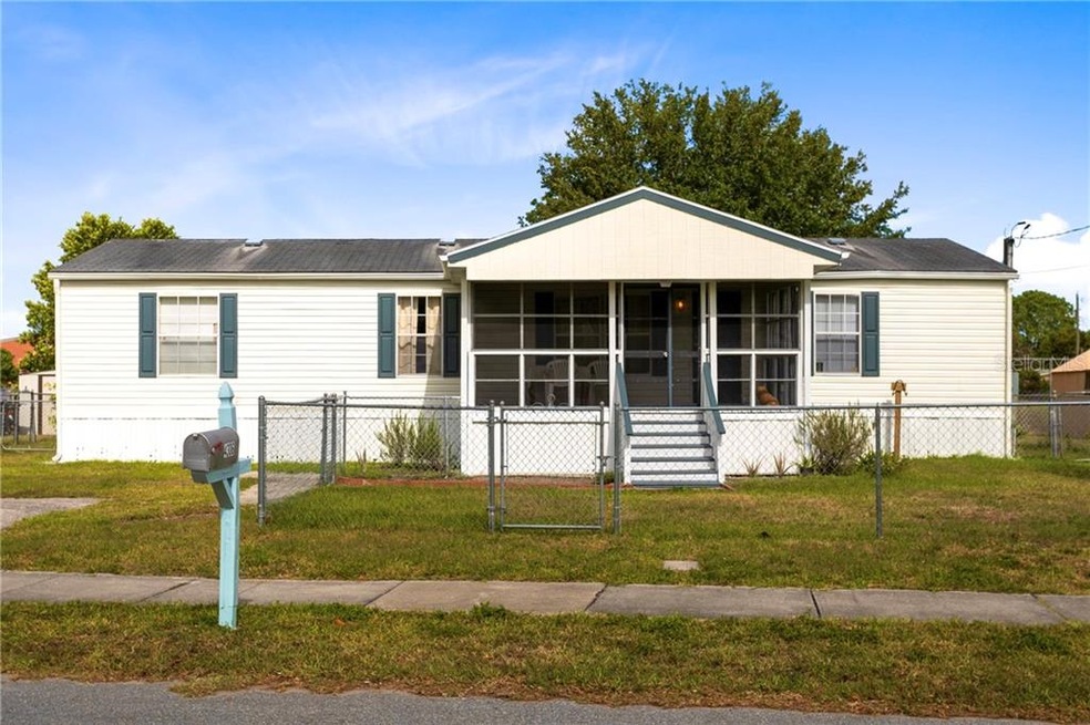 Front exterior with fenced yard.
