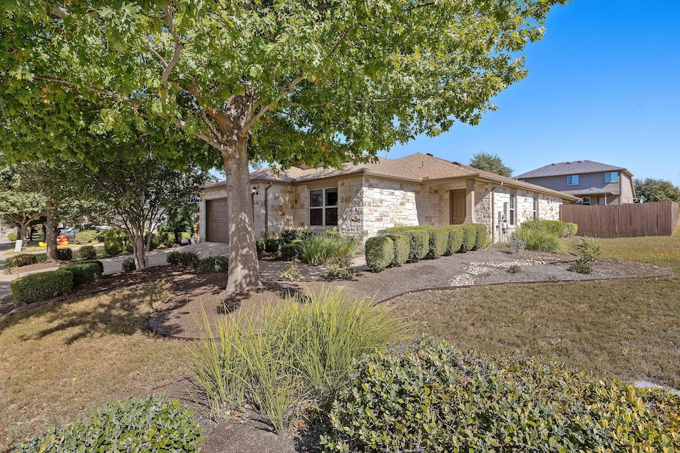 Ranch-style house featuring stone siding, an atta