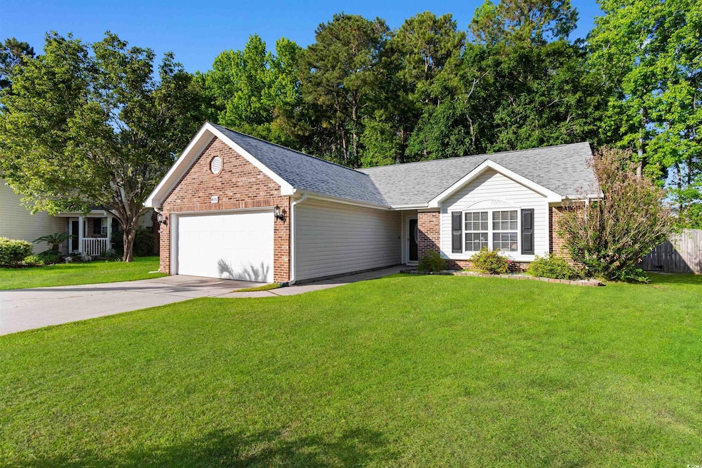 View of front of house with an attached garage, brick siding, driveway, and a shingled roof