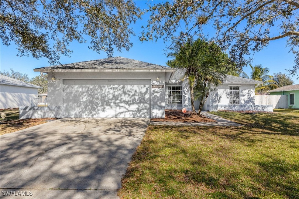 Ranch-style house with a front lawn and a garage